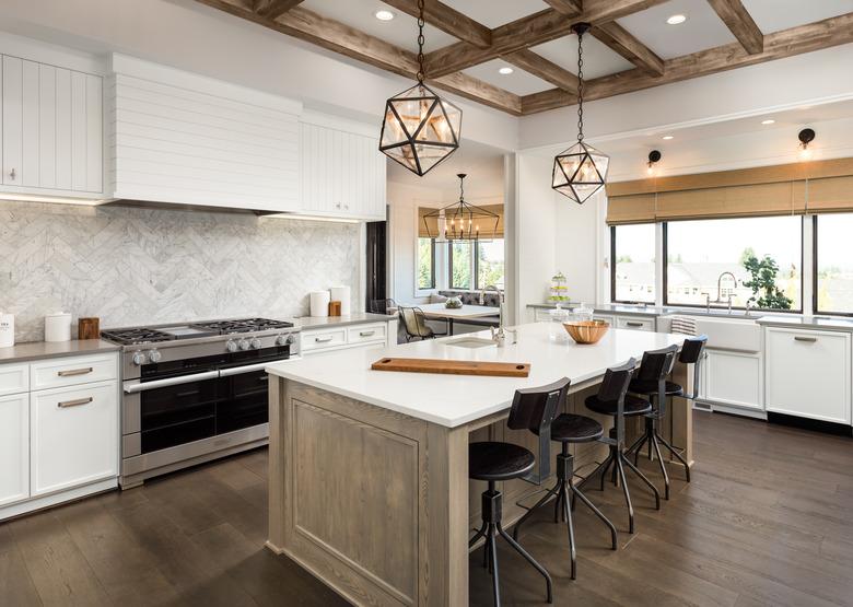 beautiful kitchen in new luxury home with island and pendant light fixtures