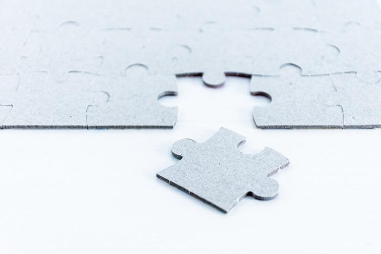 Gray puzzle pieces on white background