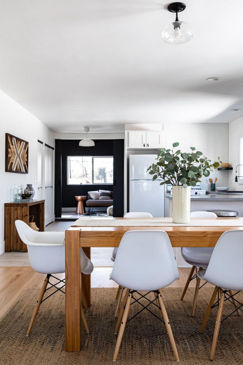 dining room with table runner on wood surface