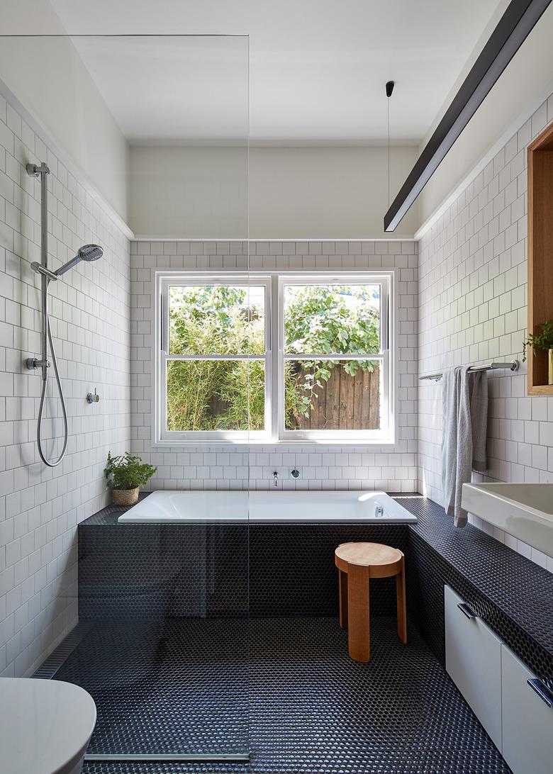 polished chrome bathroom fittings with white subway tile on walls