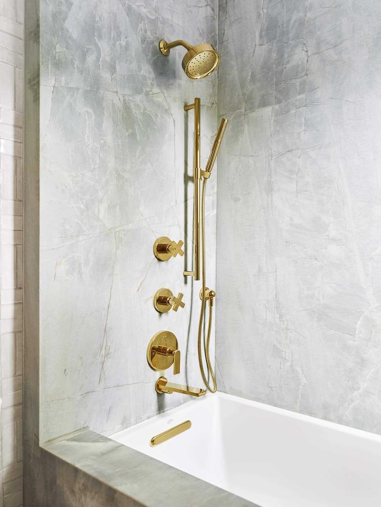 Brass plumbing fixtures in emerald quartz shower