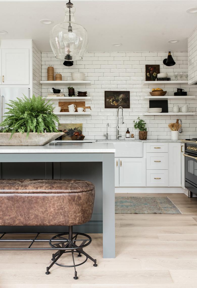 Industrial farmhouse kitchen with leather bench and subway tile backsplash