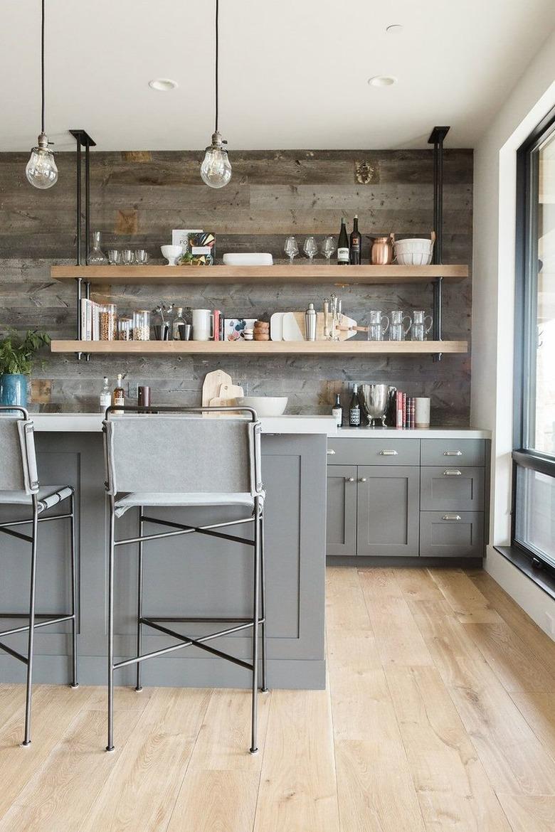 industrial pipe shelving above wet bar