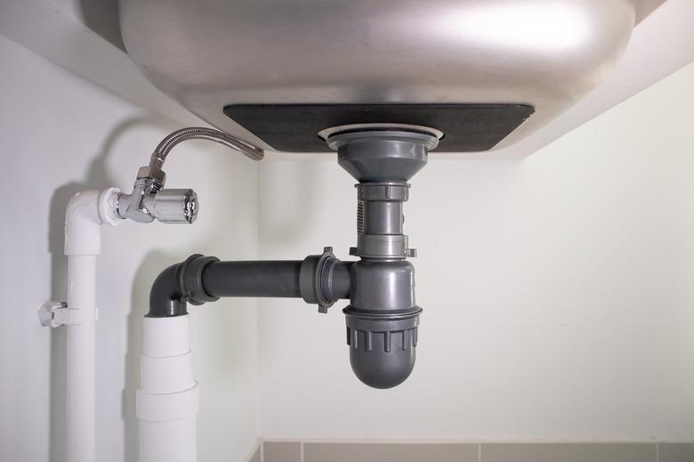 Water drain pipe under kitchen sink.