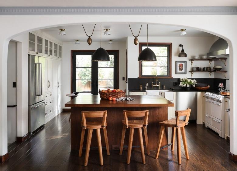 period kitchen with wood island and chairs