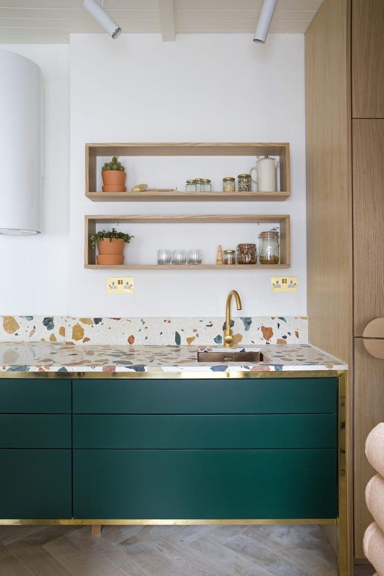 modern kitchen backsplash idea with oak cabinetry and terrazzo countertop