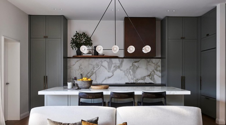 linear-oriented light fixture in sage green kitchen