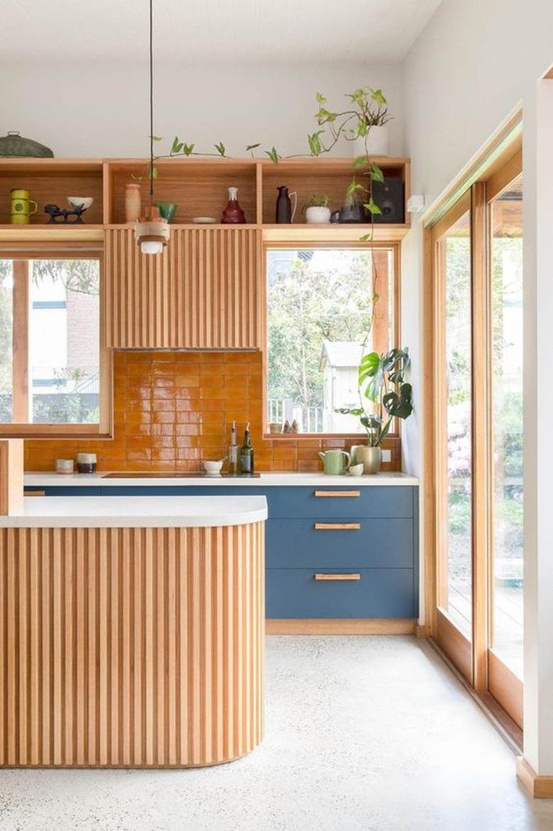 wooden kitchen cabinetry with cantaloupe orange tiling