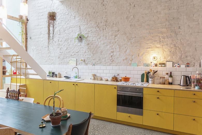 Yellow kitchen colors in kitchen with white brick walls