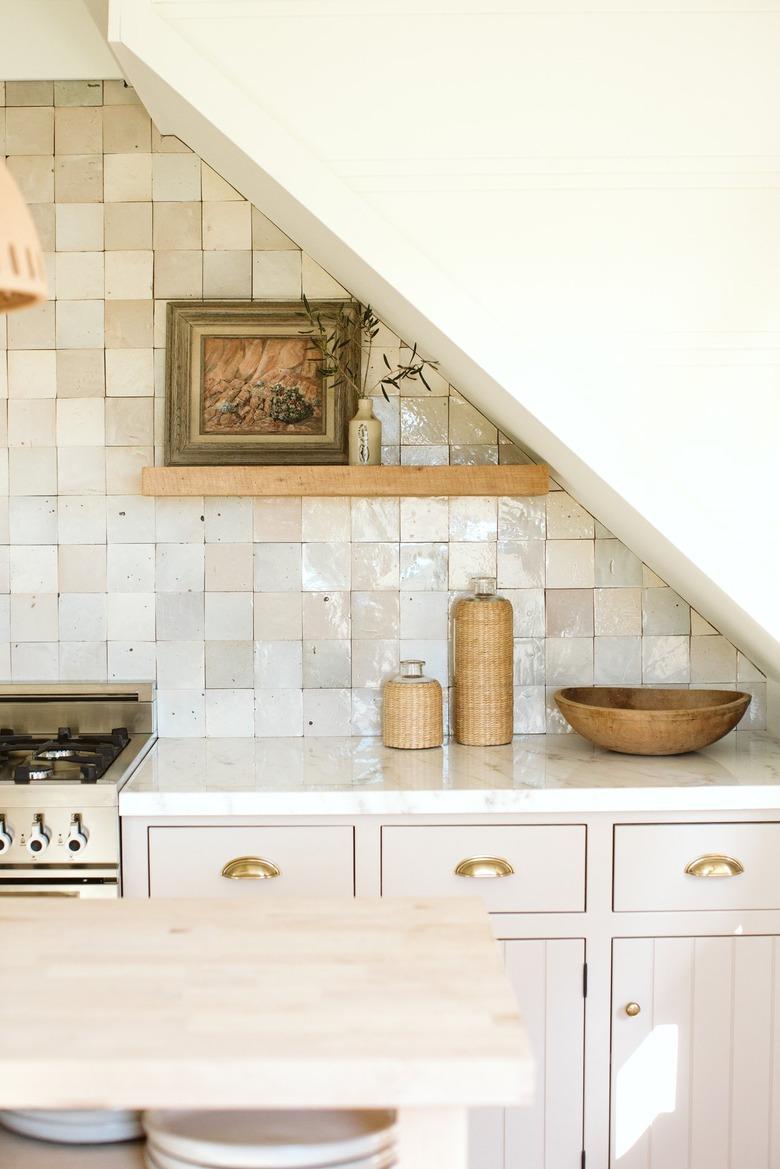 beige tiled backsplash with white kitchen counters