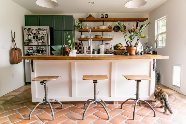 kitchen island decor with plants in kitchen with terra cotta floor