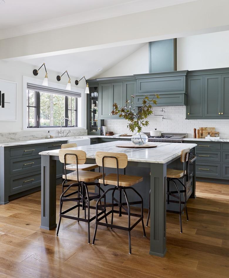 simple kitchen island decor with foliage clipping in kitchen with green cabinets