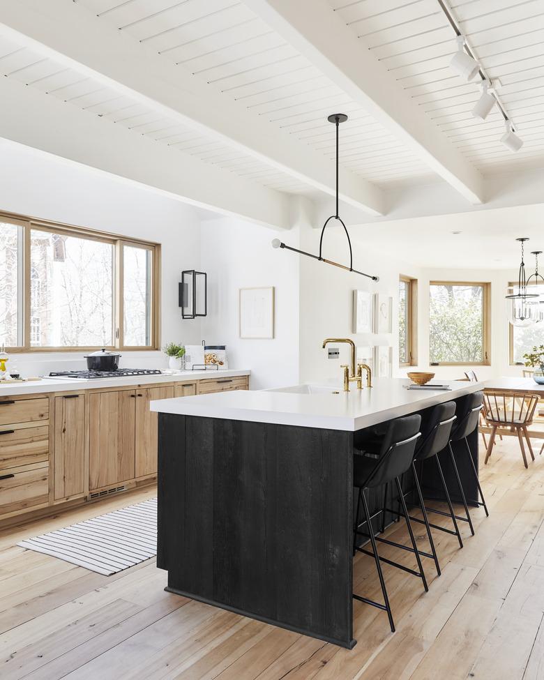 Black kitchen island table in wood and white kitchen