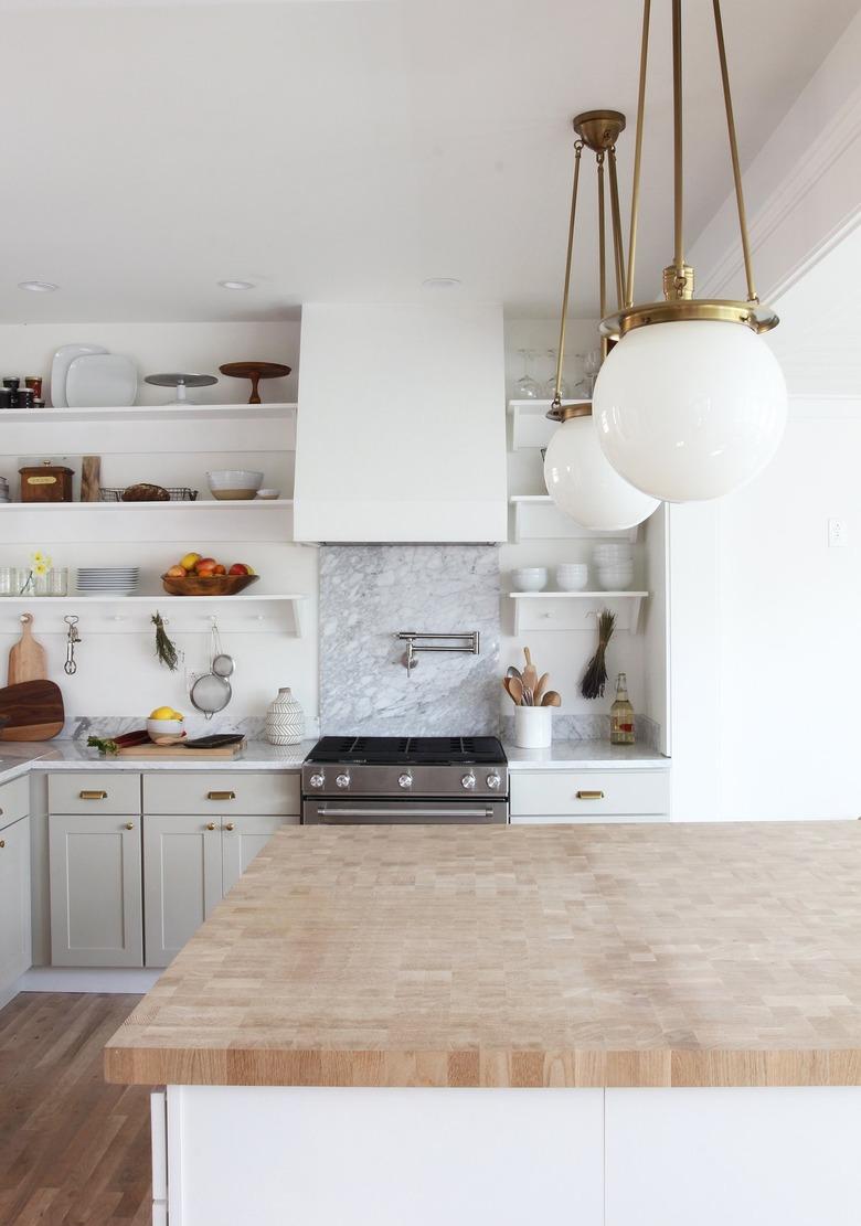 marble backsplash behind stove in white kitchen