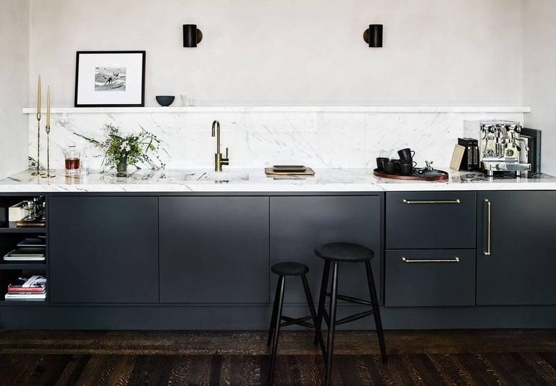 kitchen with marble backsplash and matching countertop with shelf