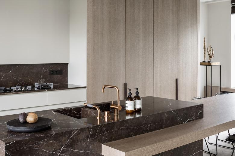 kitchen with dark marble backsplash and wood cabinetry