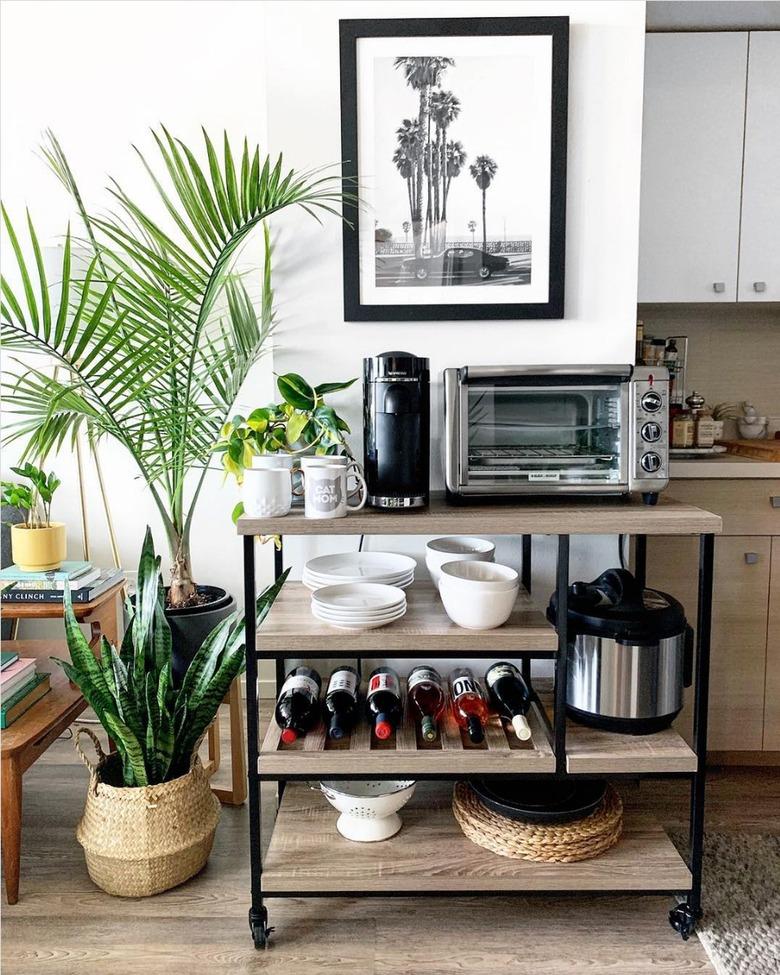 rustic wood and black kitchen cart with appliances on shelves