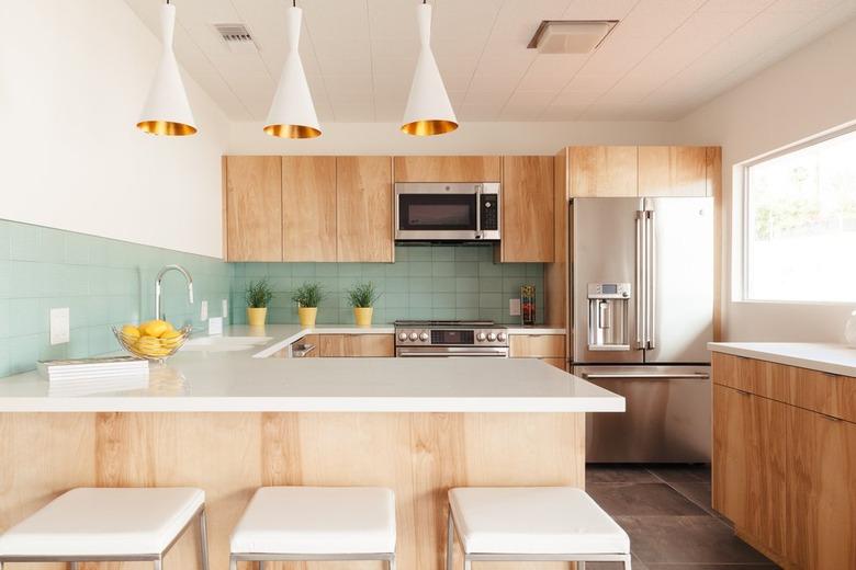 solid surface kitchen countertops with green backsplash and wood cabinets