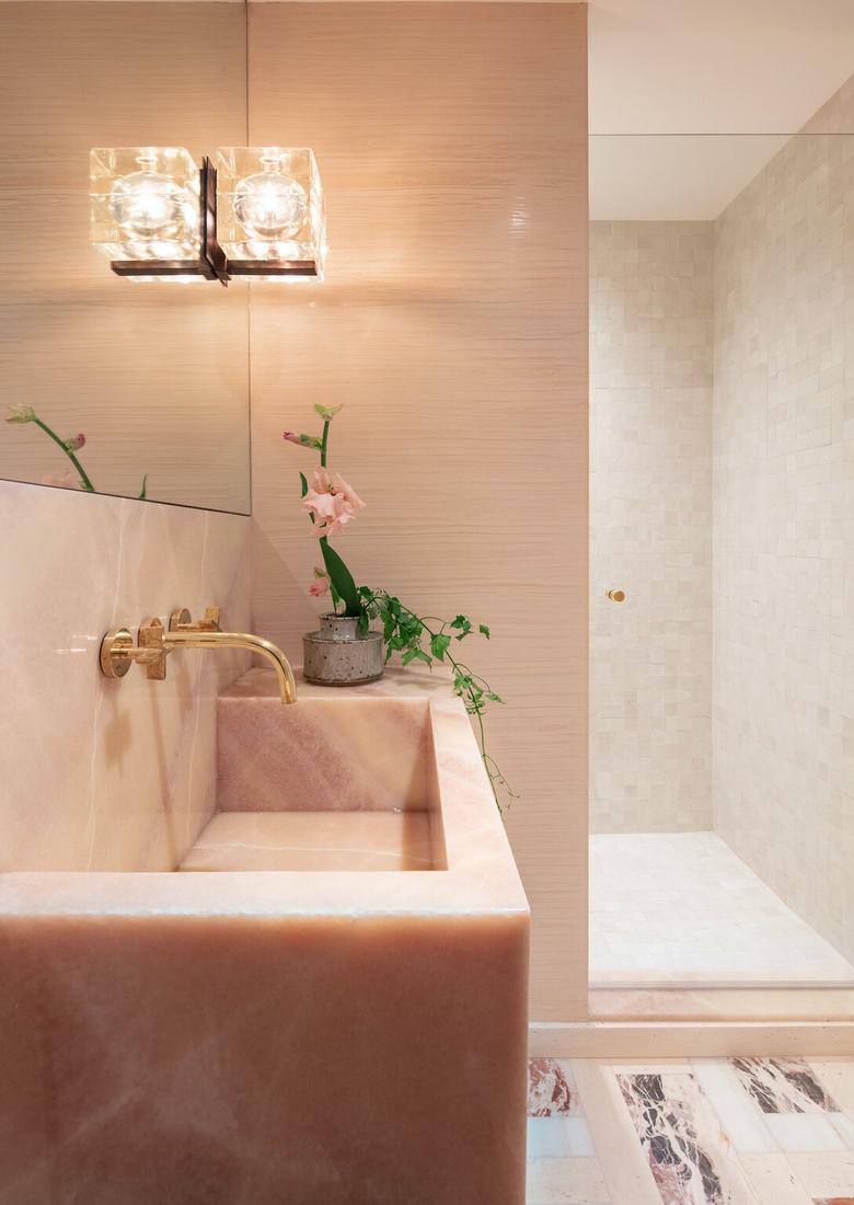 pink marble bathroom sink with brass taps