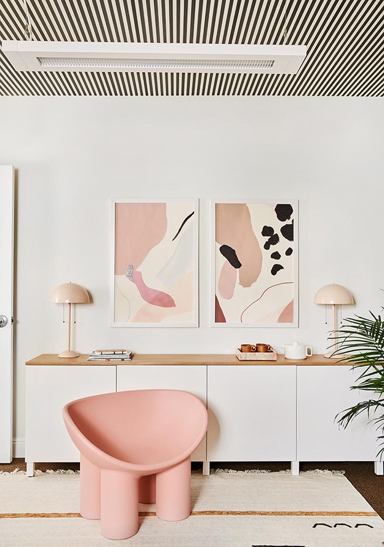 modern office with striped ceiling and pink furnishings