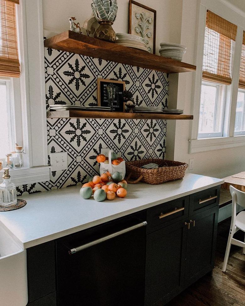 Black and white Mexican tile backsplash with open shelving and decorative pieces