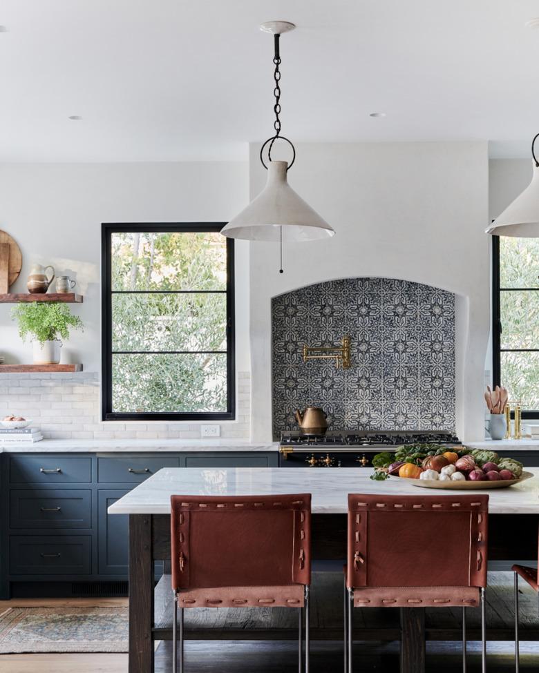 Mexican tile backsplash above oven range in open kitchen with island