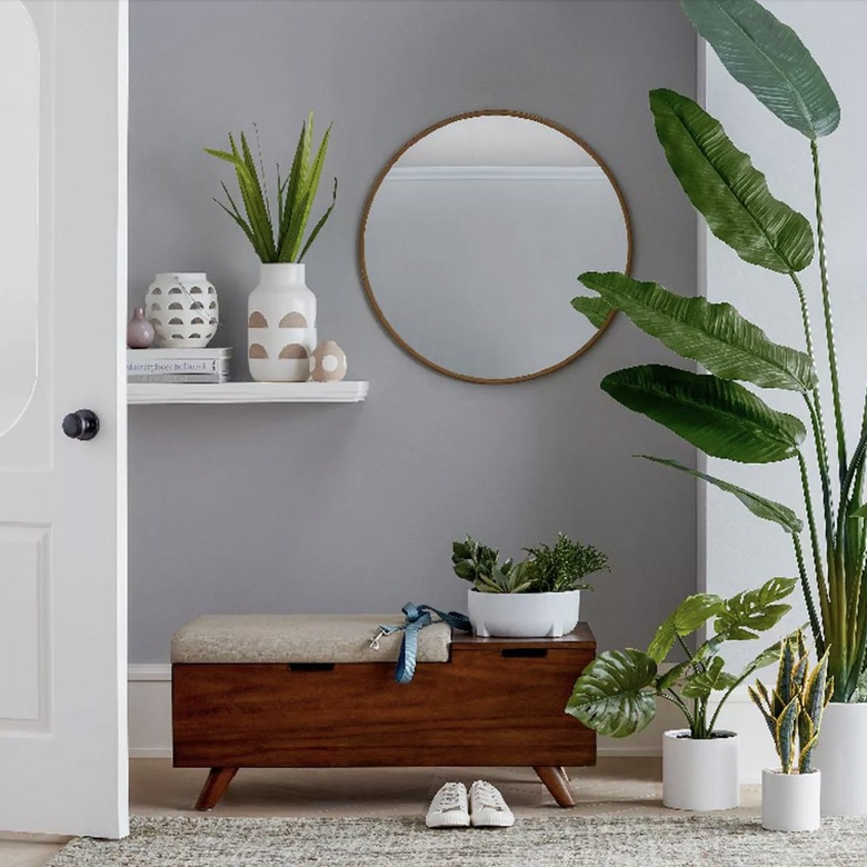 Circular mirror with plants and bench