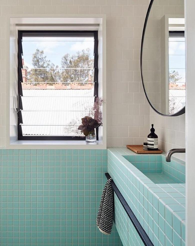 Bathroom with turquoise porcelain tile, round mirror, window, Midcentury Modern Bathroom Sink