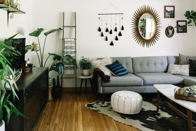 Midcentury modern bohemian living room with eclectic wall decor and midcentury sofa