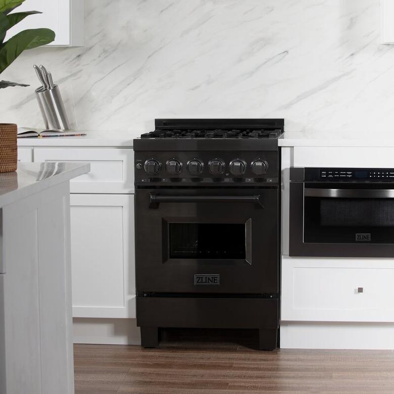 Black gas range in white kitchen. Small Stove and Oven