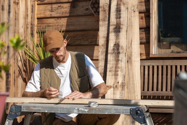 Carpenter measuring wood.