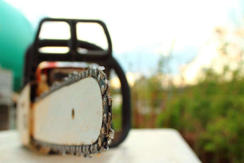 Chainsaw in the garden. Close-up. Blurred background.