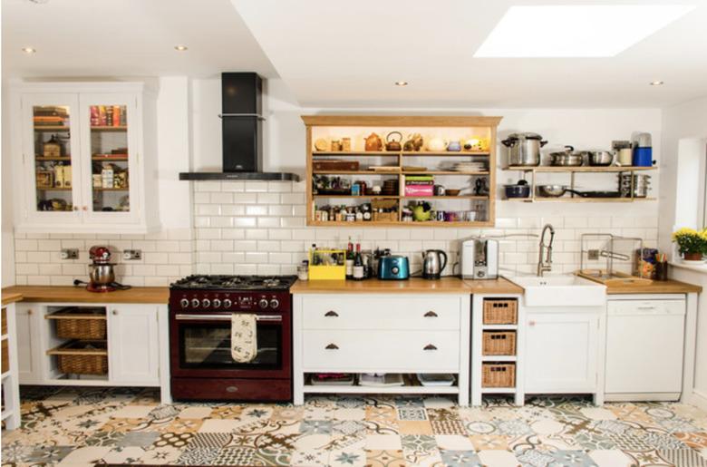 vibrant kitchen floor tile patterns in kitchen with white counters and subway tile backsplash