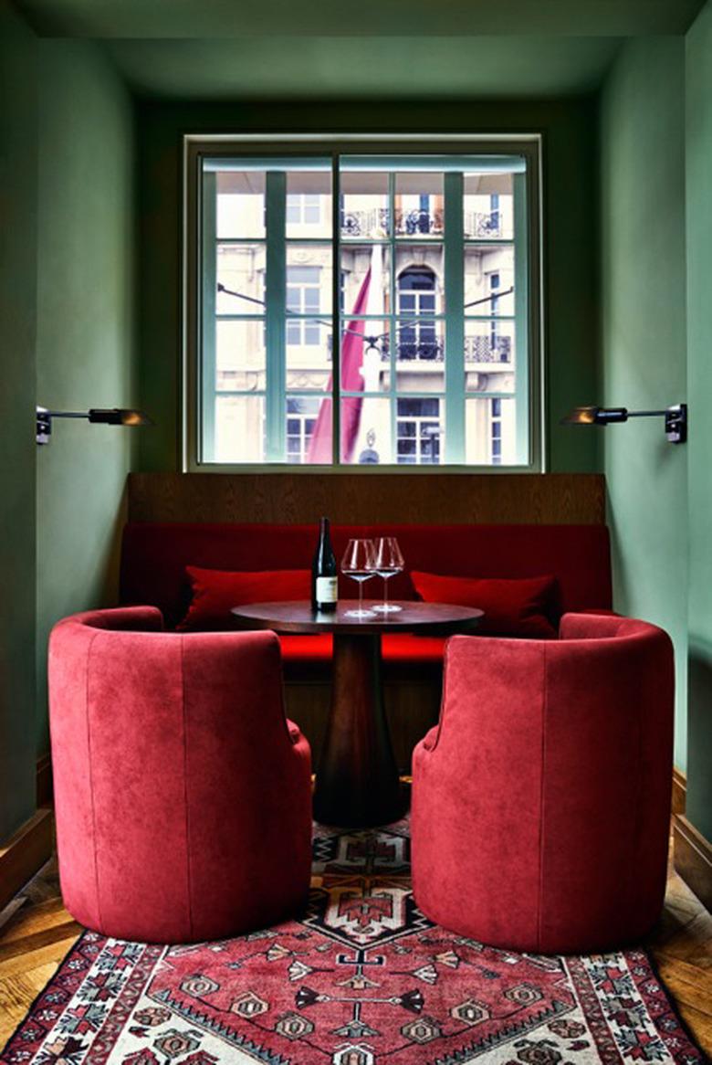 dining nook with green walls and red furniture