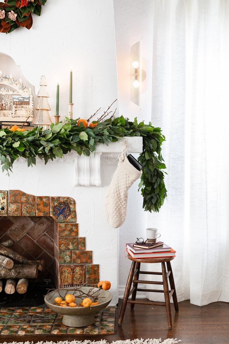 neutral Christmas decorations with garland and candlesticks on mantel for Christmas decorations list