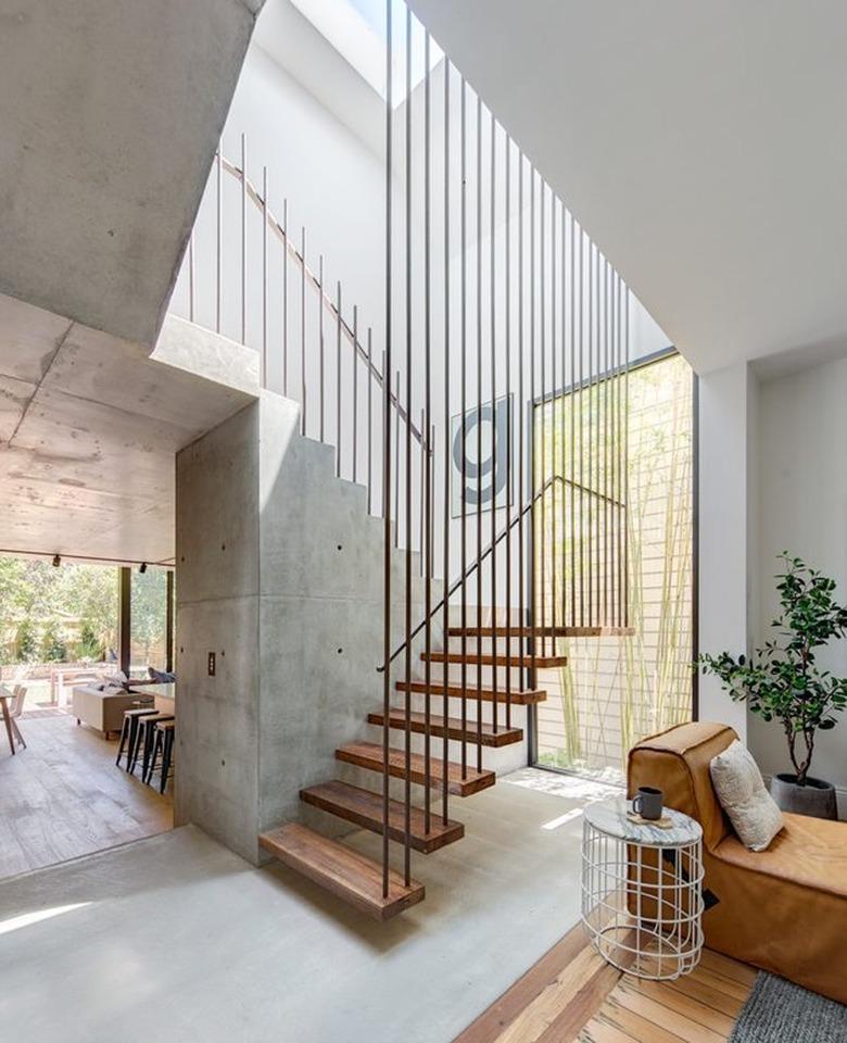 white entry with floating stairs with steel spindles