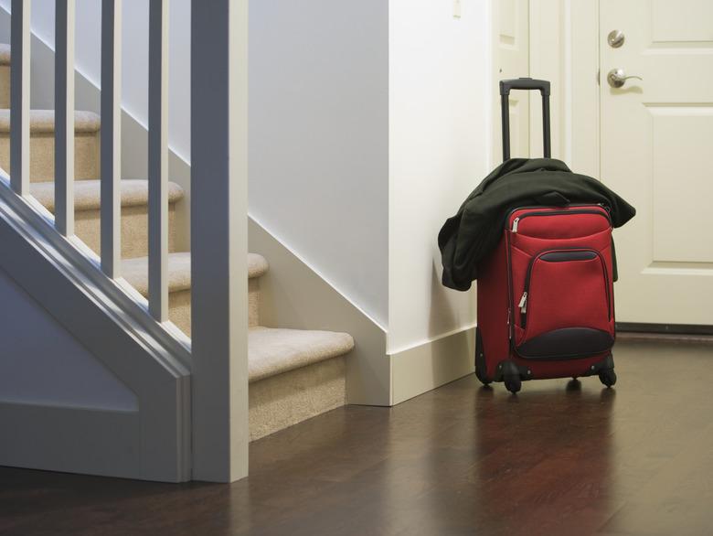 Suitcase and jacket in house foyer