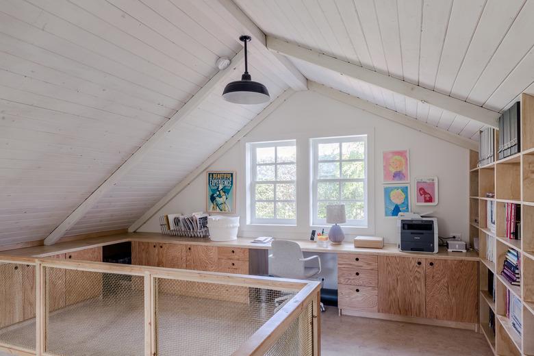 attic office idea with tongue and groove ceiling and custom plywood desks and bookcase