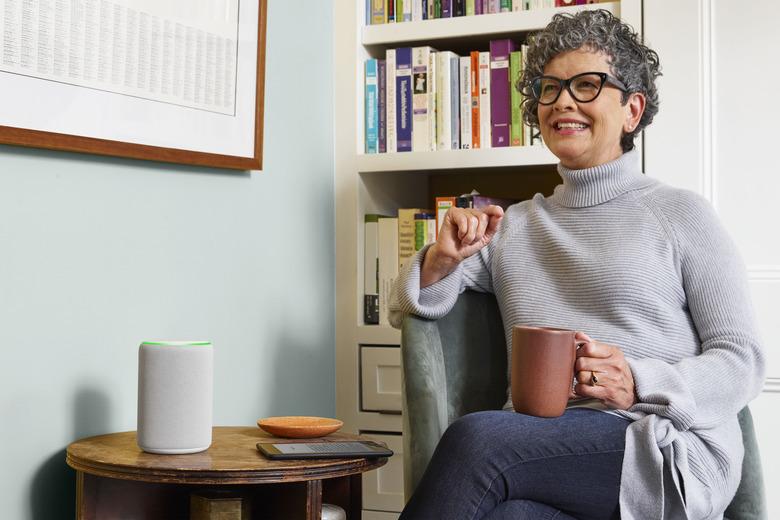 woman sitting with mug near Amazon Echo