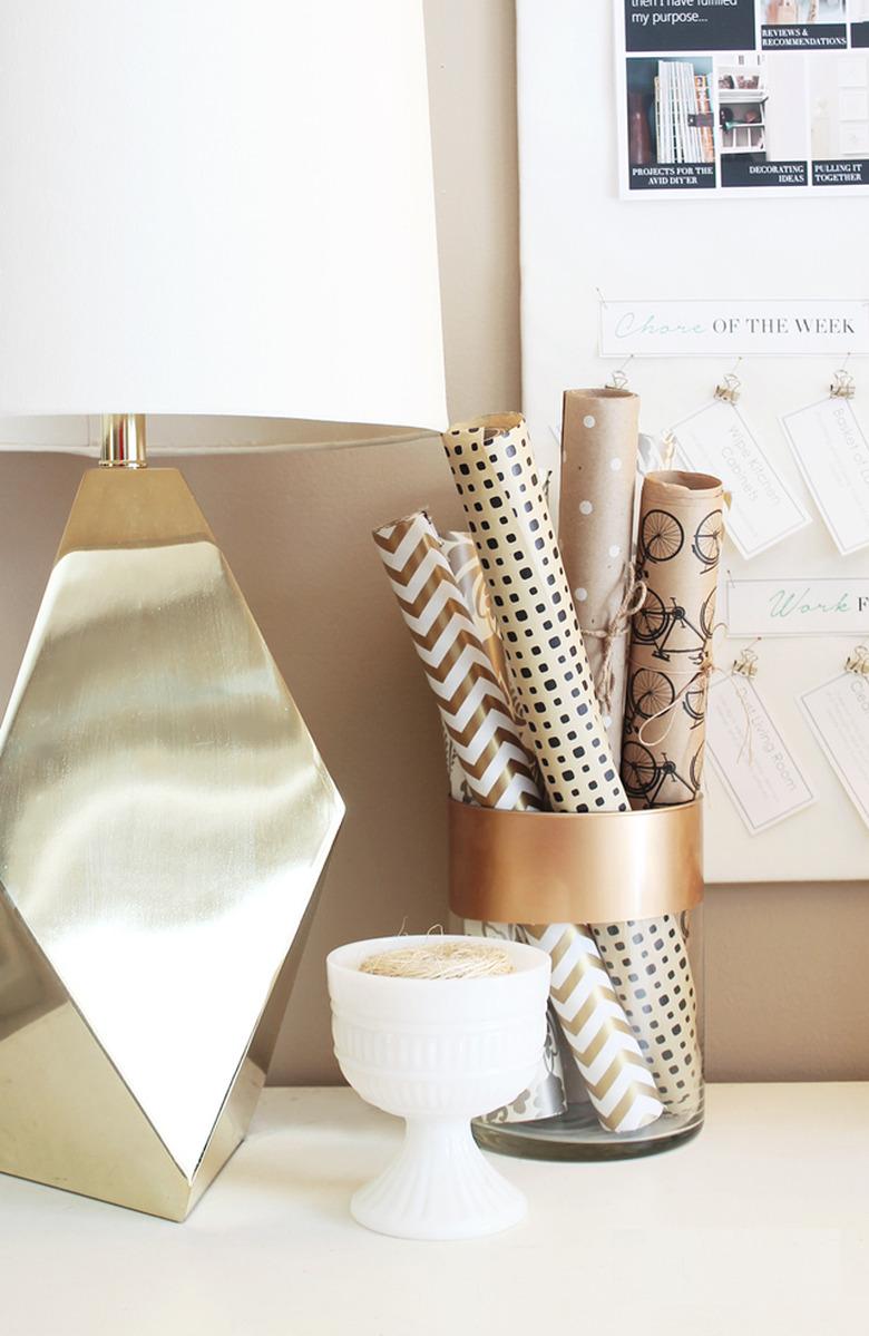 wrapping paper storage idea on desktop in glass jar