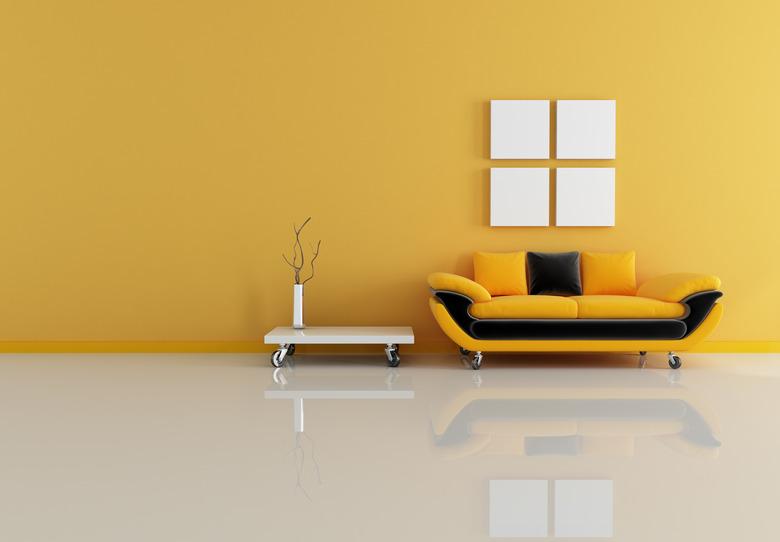 Black and orange couch and white table on casters.