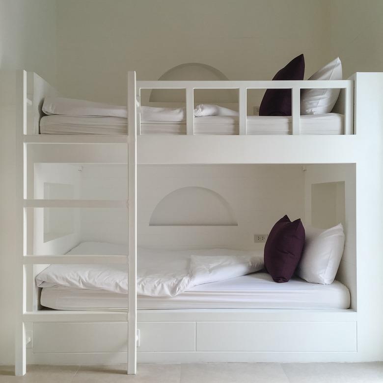 Clean hostel room with wooden bunk beds.