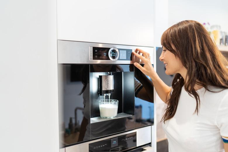 Woman and coffee machine