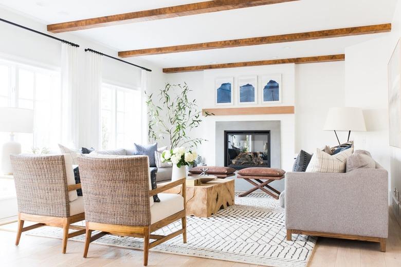 white, grey and blue coastal family room with exposed wood beams