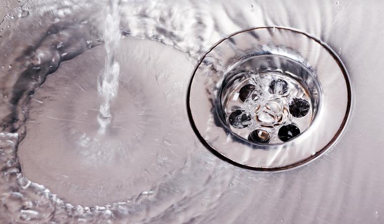 Water running down steel sink drain