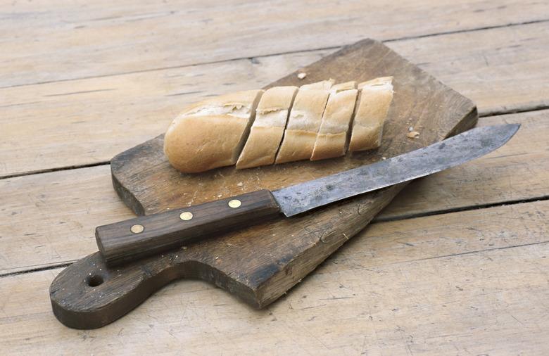 Slices of bread by knife on cutting board