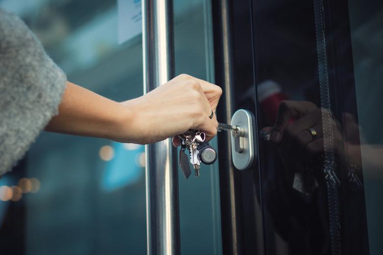 Locking door with a key.