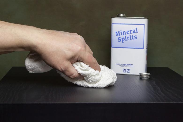 Using mineral spirits on a wood tabletop.