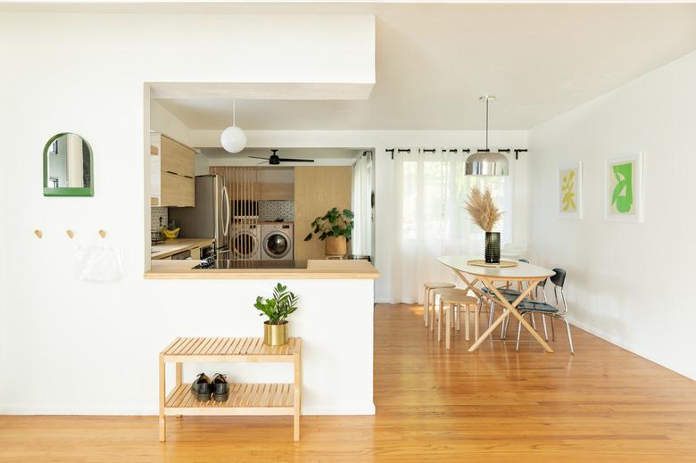 light hardwood flooring in dining area next to kitchen