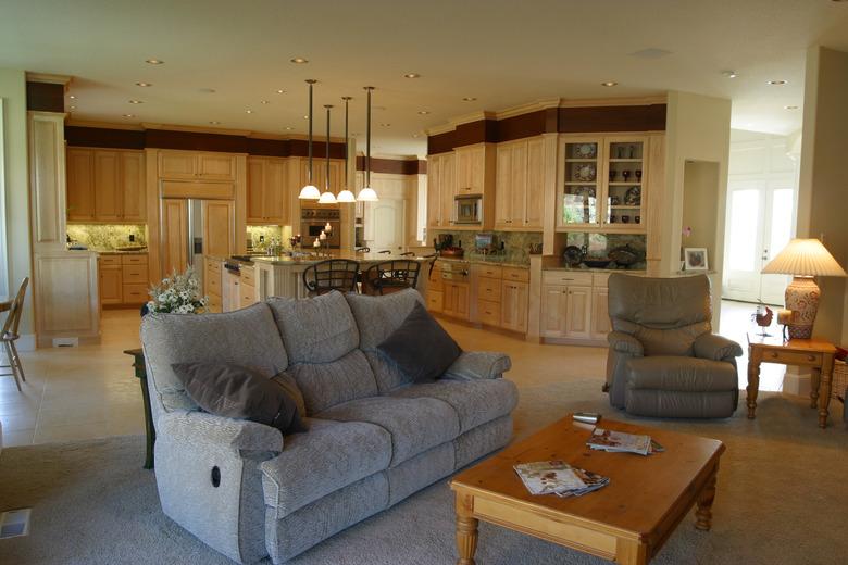 Relaxing living room with grey loveseat near kitchen